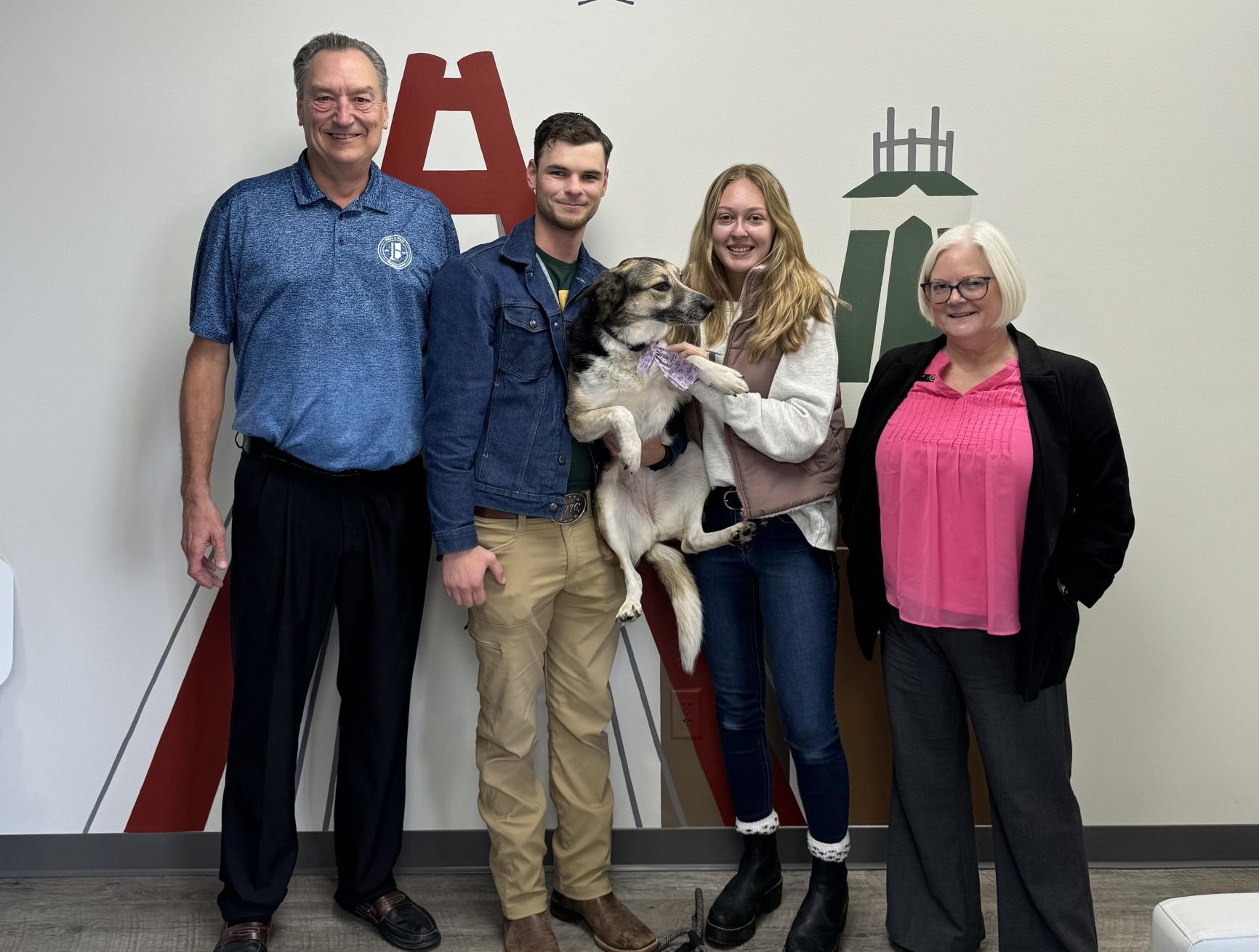 Becci Kelly, South Central Indiana Realtor, celebrating with first-time home buyers and their dog at a real estate closing in Columbus, Indiana.